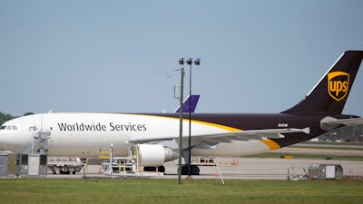 In this Tuesday, April 18, 2017 photo, a United Parcel Service cargo plane sits idle during the day as it awaits loading at Richmond International Airport in Sandston, Va.. UPS says in court records that it suspects one of its pilots obtained secret business plans for the shipping giant's aircraft fleet and posted them online. In a federal lawsuit filed the week of Oct. 6, 2017, UPS says its strategic plans are highly confidential, and says a PowerPoint presentation was intended only for senior executives.