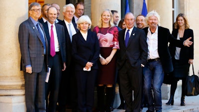 Microsoft co-founder Bill Gates, left, Sir Richard Branson, right, and special envoy to the U.N. for climate change Michael Bloomberg, second right, arrive for a meeting of philanthropists funding climate projects as part of the Climate Summit, at the Elysee Palace, in Paris, Tuesday, Dec. 12, 2017. More than 50 world leaders are gathering in Paris for a summit that Macron hopes will give new momentum to the fight against global warming, despite U.S. President Donald Trump's rejection of the Paris climate accord.