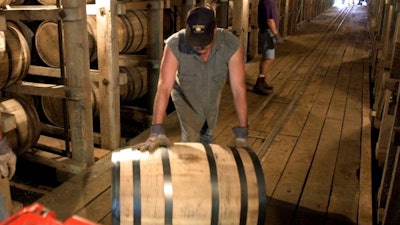 In this June 29, 2000, file photo, Tracy Matlock, left, and David Culpepper, right, move barrels of Jack Daniel's whiskey from one of the warehouses at the famous distillery in Lynchburg, Tenn. Jack Daniel's is turning to state lawmakers to ensure that distillers aren't subject to property tax on whiskey barrels in Tennessee, which the company says it hasn't had to pay since at least the end of Prohibition eight decades ago.