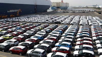 In this March 26, 2018, photo, Hyundai Motor's vehicles are seen at the company's export yard in Ulsan, South Korea. Unions at South Korea's two-largest automakers, Hyundai Motor and Kia Motors, say plans to revise a free trade deal with the United States involve concessions that will prevent local automakers from entering the fast-growing U.S. pick-up truck market.