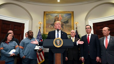 President Donald Trump, center, speaks in the Roosevelt Room of the White House in Washington, Thursday, March 8, 2018, before signing two proclamations, one on steel imports and one on aluminum imports. Standing with Trump are workers, left, Vice President Mike Pence, Treasury Secretary Steven Mnuchin and Commerce Secretary Wilbur Ross.