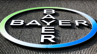 This Monday, May 23, 2016, file photo, shows the Bayer AG corporate logo displayed on a building of the German drug and chemicals company in Berlin. The German pharmaceutical giant has agreed, Tuesday, May 29, 2018, to the U.S. government's demand that it sell about $9 billion in agriculture businesses as condition for acquiring Monsanto Co., a U.S. seed and weed-killer maker.