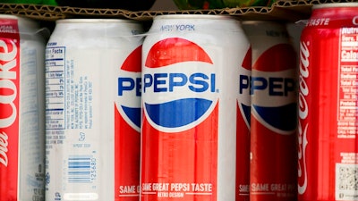In this May 7, 2018, file photo, cans of Pepsi are displayed in New York. PepsiCo Inc. reports earns on Tuesday, July 10.