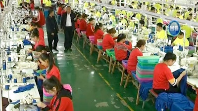 In this file image from undated video footage run by China's CCTV via AP Video, Muslim trainees work in a garment factory at the Hotan Vocational Education and Training Center in Hotan, Xinjiang, northwest China. China's state broadcaster CCTV aired the report Tuesday, Oct. 16, 2018, on the so-called vocational education and training center, with Muslim trainees telling the camera how they have been saved from dangerous and poor lives and how grateful they are to the authorities.