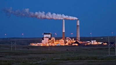 In this May 25, 2017, file photo, the Milton R. Young Station lignite coal-fired power plant near Center, N.D., glows as dusk blankets the North Dakota prairie landscape. The U.S. Environmental Protection Agency announced Tuesday, Feb. 26, 2019, it will retain the standard for sulfur dioxide pollution established in 2010 under President Barack Obama. Sulfur dioxide comes from burning coal to produce electricity and from other industrial sources.