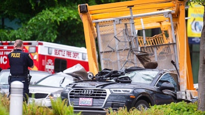 Emergency crews work the scene of a construction crane collapse near the intersection of Mercer Street and Fairview Avenue near Interstate 5 in Seattle, on Saturday, April 27, 2019. Authorities say several people have died and a few others are hospitalized after the construction crane fell onto a street in downtown Seattle Saturday afternoon.