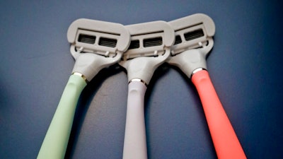 In this Oct. 11, 2018 file photo razors from Harry's shaving and body care brand Flamingo are displayed in New York. Edgewell Personal Care is acquiring upstart razor maker Harry’s in a cash-and-stock deal for $1.37 billion. Edgewell and other larger personal care companies have been steadily losing market share to smaller, direct-to-consumer companies like Harry’s, known for its brightly-colored disposable razors.