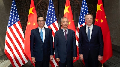 Chinese Vice Premier Liu He, center, poses with U.S. Trade Representative Robert Lighthizer, right, and Treasury Secretary Steven Mnuchin, for photos before holding talks at the Xijiao Conference Center in Shanghai Wednesday, July 31, 2019.