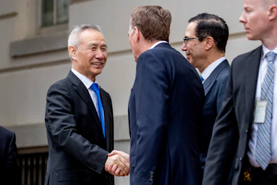 In this May 10, 2019 file photo, China's Vice Premier Liu He, left is greeted by U.S. Treasury Secretary Steve Mnuchin, second from right, and U.S. Trade Representative Robert Lighthizer, third right, as he arrives at the Office of the United States Trade Representative in Washington.