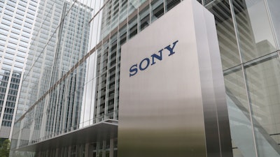 In this July 19, 2019, file, photo, people walk out from the headquarters of Sony Corp., in Tokyo.
