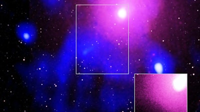This image made available by NASA on Thursday, Feb. 27, 2020 shows the Ophiuchus galaxy cluster viewed in a composite of X-ray, radio and infrared data. The inset image at bottom right shows data from the Chandra X-ray Observatory which confirmed a cavity formed by a record-breaking explosion from a super-massive black hole.