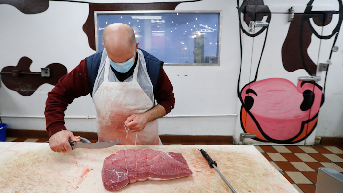 John Warminski prepares meat at Ronnie's Quality Meats in Detroit on Wednesday, April 29. President Donald Trump has ordered meat processing plants to stay open amid concerns over growing coronavirus COVID-19 cases and the impact on the nation's food supply.