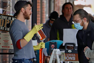 In this April 16 photo, people line up to purchase Pennsylvania made liquor at Pennsylvania Libations in Pittsburgh's Strip District. The Pennsylvania liquor control board closed the Pennsylvania state-owned stores that retail nearly all of Pennsylvania's liquor in March, driving up demand from the state's distilleries, which have been allowed to continue production and sales, although some report stockpiles are rapidly drying up.