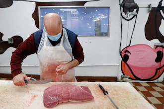 John Warminski prepares meat at Ronnie's Quality Meats in Detroit on Wednesday, April 29. President Donald Trump has ordered meat processing plants to stay open amid concerns over growing coronavirus COVID-19 cases and the impact on the nation's food supply.