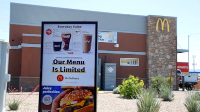 In this April 20, 2020 file photo, a new sign lets drive-thru customers know that the available menu at a local McDonalds is no longer complete due to the ongoing coronavirus restrictions in Phoenix.