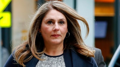 In this Feb. 25, 2020, file photo, Michelle Janavs arrives at federal court in Boston for sentencing in a nationwide college admissions bribery scandal. Lawyers for Janavs, who is supposed to report to prison in May, said in a legal filing Wednesday, April 22, 2020, that she should spend five months in home confinement instead of prison because she has an underlying health condition that makes her particularly vulnerable if she were to contract the coronavirus.