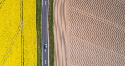 A lorry drives along a country road that between a flowering rape field and a freshly tilled field in Pattensen, Germany on April 28.