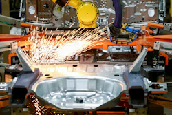 In this June 24, 2019, file photo machines work on a Ford vehicle assembly line at Ford's Chicago Assembly Plant in Chicago.