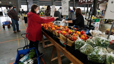 Carrie Simpson shops at the Detroit Farmers Market on Saturday, May 2 in Detroit.