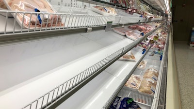 A meat case at a Publix Super Market in Atlanta is mostly empty of chicken on Tuesday, May 5. This Publix store is limiting shoppers to two packages of chicken, like a number of other grocery retailers due to supply concerns amid the COVID-19 pandemic.