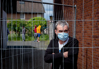Iulian, Romanian worker who stands behind the fence that was set up at the entrance of a housing of Romania slaughterhouse workers in Rosendahl, Germany on Tuesday, May 12.