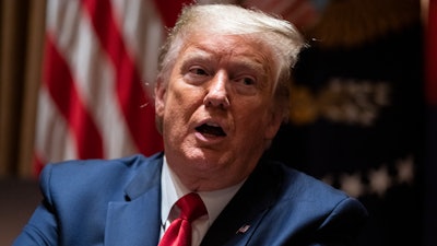 President Donald Trump speaks during a meeting with North Dakota Gov. Doug Burgum and Colorado Gov. Jared Polis on the coronavirus response, in the Cabinet Room of the White House on Wednesday, May 13.