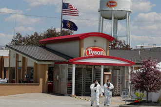 In this May 7 photo, workers leave the Tyson Foods pork processing plant in Logansport, IN.