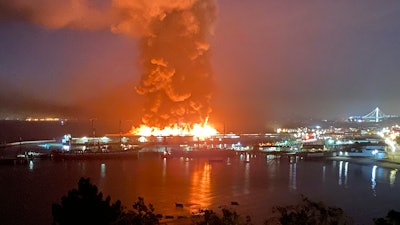 This photo courtesy of Dan Whaley, @dwhly, shows a warehouse fire burning at San Francisco's Fisherman's Wharf in San Francisco early Saturday, May 23. The fire tore through the warehouse, sending thick smoke over the waterfront and causing its walls to collapse.