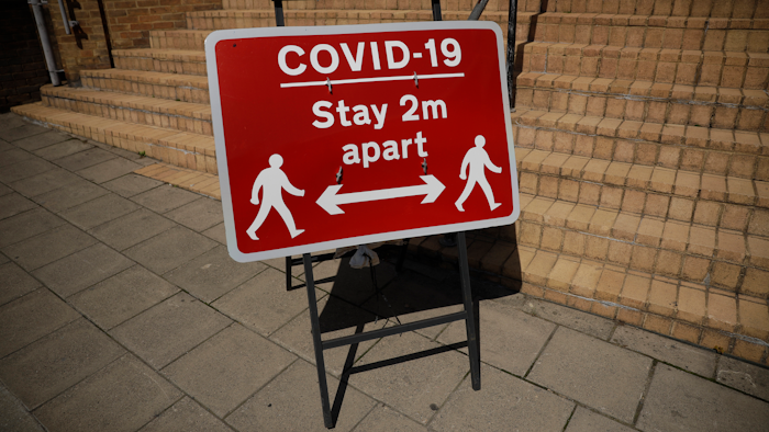 A sign requesting people stay two metres apart is displayed in Kingston upon Thames, south west London on Monday, June 22. The two-metre social distancing rule will be under review as the UK relax coronavirus lockdown measures implemented to stem the spread of the virus.