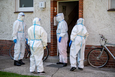 Members of German Red Cross (DRK) stand in front of a house where employees of the Toennies meat factory live in Rheda-Wiedenbrueck, Germany on Monday, June 22.