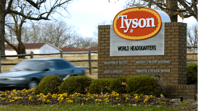 In this Jan. 29, 2006 photo, a car passes in front of a Tyson Foods sign at the company's headquarters in Springdale, Ark. China's decision to ban imports from a single Tyson Foods poultry plant because of concerns about a coronavirus outbreak there puzzled many in the meat industry and raised concerns about whether this could threaten a major market for U.S. meat.