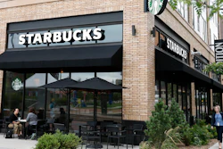In this July 10, 2019 photo, customers visit at a Starbucks in Minneapolis. Starbucks is adding plant-based meat to its U.S. menu for the first time.