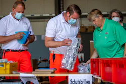 Mobile teams testing people on the coronavirus collect their equipment at a fire station in Rheda-Wiedenbrueck, Germany on Monday, June 23. The mobile teams from the German Federal Armed Forces and aid organizations are formed to visit and test people in quarantine throughout the Guetersloh region.