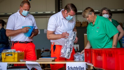 Mobile teams testing people on the coronavirus collect their equipment at a fire station in Rheda-Wiedenbrueck, Germany on Monday, June 23. The mobile teams from the German Federal Armed Forces and aid organizations are formed to visit and test people in quarantine throughout the Guetersloh region.