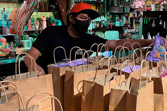 This photo provided by Lei Low Bar shows David Perez, organizing To-go orders at the Lei Low Bar in Houston on June 25.