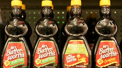 In this Nov. 20, 2007 file photo, bottles of Mrs. Butterworth's syrup are displayed on a supermarket shelf in Basking Ridge, N.J. Mrs. Butterworth and Cream of Wheat are the latest brands reckoning with racially charged logos. Chicago-based Conagra Brands, which makes Mrs. Butterworth’s syrup, said its female-shaped bottles are intended to evoke a “loving grandmother.” But the company said it can understand that the packaging could be misinterpreted. The soul-searching comes in the wake of PepsiCo's announcement Wednesday, June 17, 2020, that it's renaming its Aunt Jemima syrup brand.
