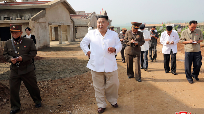 In this undated photo provided on Thursday, July 23 by the North Korean government, North Korean leader Kim Jong Un visits a new chicken farm being built in Hwangju County, North Korea. Independent journalists were not given access to cover the event.