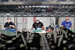 In this May 13, 2020 photo, Ford Motor Co. line workers put together ventilators that the automaker is assembling at the Ford Rawsonville plant in Ypsilanti Township, Mich. American industry rebounded last month as factories began to reopen for the first time since being shut down by the coronavirus in Aprll.