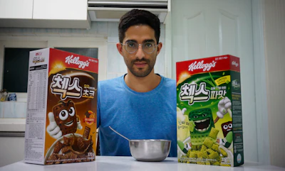 Journalist Raphael Rashid poses with two cereal boxes, including the new green onion flavored Chex cereal in Seoul, South Korea on Wednesday, July 1.