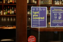 Signs advising social distancing and wearing face masks are posted on a door of The Barrel Room restaurant during the coronavirus outbreak in San Francisco on July 14. The Barrel Room, a San Francisco wine bar and restaurant, cautiously reopened last week, hoping to salvage as much of 2020 as possible from the coronavirus pandemic and the lockdowns meant to contain it.