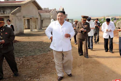 In this undated photo provided on Thursday, July 23 by the North Korean government, North Korean leader Kim Jong Un visits a new chicken farm being built in Hwangju County, North Korea. Independent journalists were not given access to cover the event.