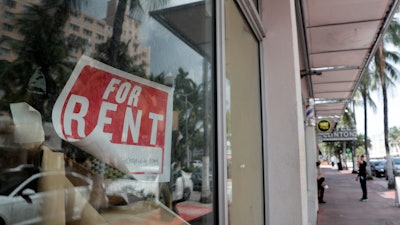 For Rent sign hangs on a closed shop.