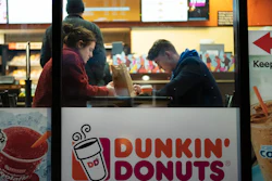 In this Jan. 30, 2019 file photo, customers sit inside a Dunkin' Donuts in New York.