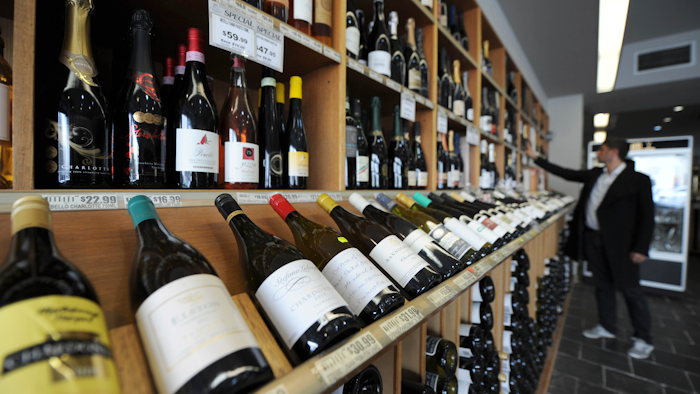 In this 2012 file photo, a shopper looks over the wine at King & Godfree, one of Australia's oldest licensed grocery stores in, Melbourne, Australia.