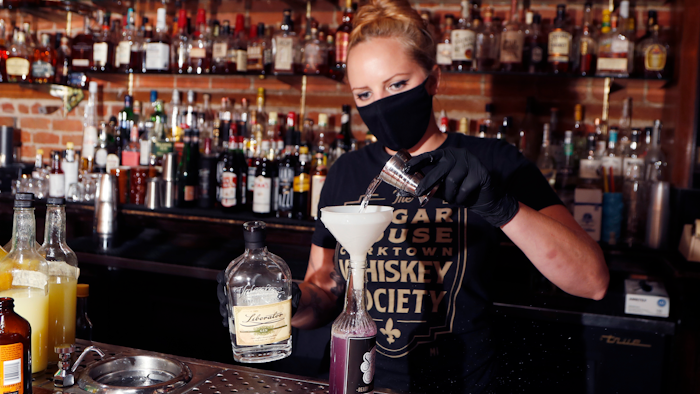 Sugar House bartender Shelby Minnix creates a Lavender Lemonade cocktail in a to-go bottle on Aug. 13 in Detroit.