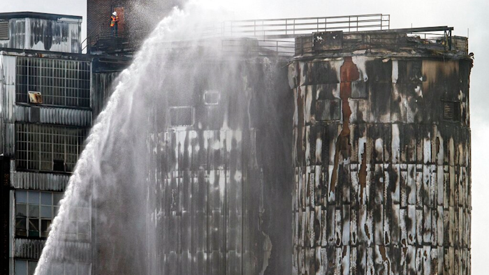 St. Bernard firefighters battle a 3-alarm fire after silos caught fire at the century-old Domino Sugar Refinery in Arabi, La., Thursday, Aug. 27, 2020.