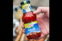In this 2014 photo, a man holds a bottle of 'gypsy sauce' from the manufacturer Knorr in his hand in Berlin, Germany.