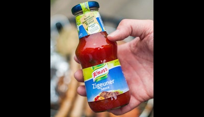 In this 2014 photo, a man holds a bottle of 'gypsy sauce' from the manufacturer Knorr in his hand in Berlin, Germany.
