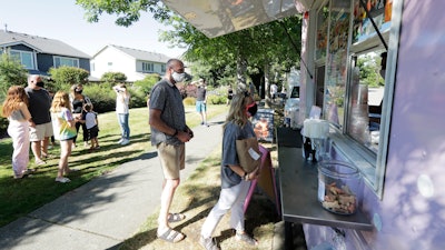 Julie and Greg Schwab wait to order from the Dreamy Drinks food truck on Aug. 10 near the suburb of Lynnwood, WA, north of Seattle.