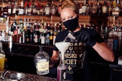 Sugar House bartender Shelby Minnix creates a Lavender Lemonade cocktail in a to-go bottle on Aug. 13 in Detroit.